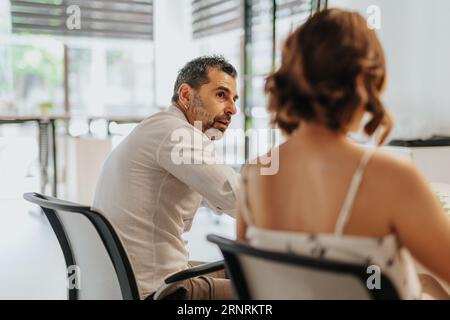 Diverse business team analyzing statistics, discussing profit growth, and planning project development in an office. Stock Photo