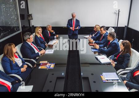 Elderly businessman working together on a new big business project with his senior employees. Large senior business team working together on a new bus Stock Photo