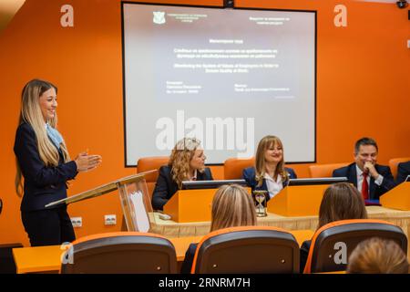 Group of students and professors getting ready to hear their student present a project Stock Photo