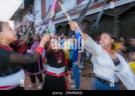 Nepal. 2nd Sep, 2023. Youth performs traditional dance known as ''˜Ghintang Ghisi' with sticks as they take part in a procession during Gai Jatra or Cow Festival celebrated in Bhaktapur, Nepal. Nepali people celebrate Gai Jatra festival in the memory of departed souls in the past year. It is believed that cows guide the departed souls to cross the river to get to heaven. (Credit Image: © Amit Machamasi/ZUMA Press Wire) EDITORIAL USAGE ONLY! Not for Commercial USAGE! Stock Photo