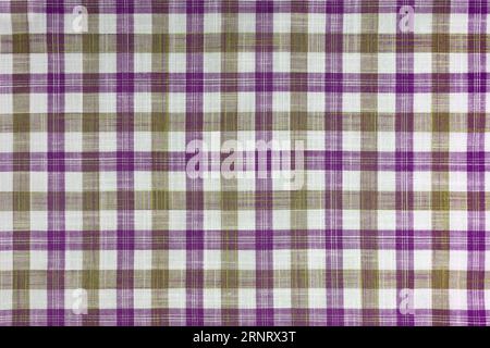 Purple and khaki checkered texture fabric, tartan pattern. Shirt fabric, tablecloth textile, linen plaid cloth, classic scottish check pattern. Backdr Stock Photo