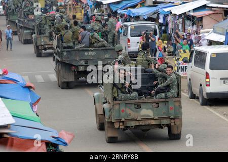 (171021) -- MARAWI, Oct. 21, 2017 -- Soldiers from the Philippine Marine Battalion Landing Team (MBLT) and Marine Special Operation Group (MARSOG) wave as they travel their way back from their combat duty against pro-Islamic State (IS) militants in Marawi City, the Philippines, Oct. 21, 2017. Abu Sayyaf leader Isnilon Hapilon has been killed in an assault in the Philippine southern city of Marawi, Philippine Defense Secretary Delfin Lorenzana said on Saturday, citing the United States Federal Bureau of Investigation (FBI). Hapilon, with alleged link to Islamic State (IS) extremists, is one of Stock Photo