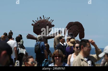 (171022) -- SYDNEY, Oct. 22, 2017 -- Visitors view sculptures at the Bondi beach in Sydney, Australia, on Oct. 22, 2017. Sculpture by the Sea, Australia s famous annual outdoor art exhibition, celebrated its 21st anniversary this year. ) (swt) AUSTRALIA-SYDNEY-SCULPTURES BaixXuefei PUBLICATIONxNOTxINxCHN Stock Photo