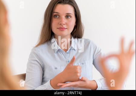 Woman having conversation with someone using sign language Stock Photo