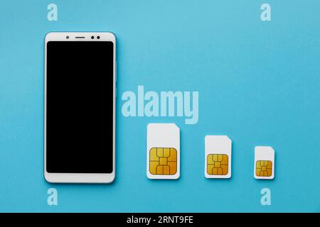 Top view three sim cards with smartphone copy space Stock Photo