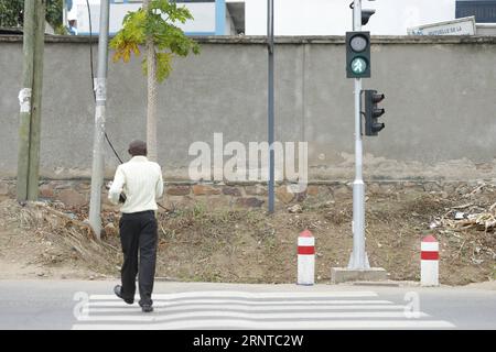 (171105) -- BUJUMBURA, Nov. 5, 2017 -- A pedestrian crosses a road in Bujumbura, capital of Burundi, on Nov. 5, 2017. Traffic lights in Burundi stopped functioning due to a lack of repair mechanism less than one year after being installed in 1999. Funded by the African Development Bank, STECOL Corporation, a Chinese firm focusing on engineering and construction works, started installing traffic lights at 19 street corners across Bujumbura in May. All of the traffic lights, made in China, have been put to use since August. ) (djj) BURUNDI-BUJUMBURA-CHINA-TRAFFIC LIGHTS EvrardxNgendakumana PUBLI Stock Photo