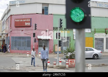 171105 -- BUJUMBURA, Nov. 5, 2017 -- Pedestrians cross a road in Bujumbura, capital of Burundi, on Nov. 5, 2017. Traffic lights in Burundi stopped functioning due to a lack of repair mechanism less than one year after being installed in 1999. Funded by the African Development Bank, STECOL Corporation, a Chinese firm focusing on engineering and construction works, started installing traffic lights at 19 street corners across Bujumbura in May. All of the traffic lights, made in China, have been put to use since August.  djj BURUNDI-BUJUMBURA-CHINA-TRAFFIC LIGHTS EvrardxNgendakumana PUBLICATIONxN Stock Photo