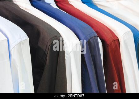 men's multi-colored shirts in the market Stock Photo