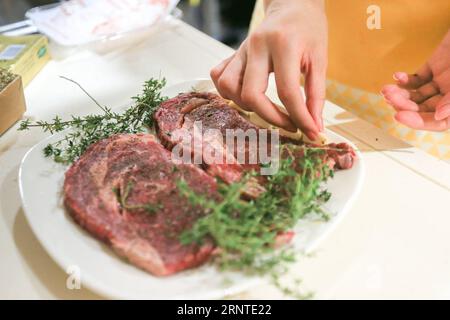(171107) -- SHANGHAI, Nov. 7, 2017 -- Photo taken on Nov. 2, 2017 shows a local resident marinating beef that imported from the United States, in Shanghai, east China. Though it is the home of U.S. billionaire investor Warren Buffett, Omaha was little known to Chinese a few months ago. But now this city in the midwestern Nebraska state is poised to become a household name in China since its Greater Omaha Packing company sent about 40 boxes of its products to China on June 14, soon days after the United States and China reached a deal to re-open Chinese markets for U.S. beef as part of their 10 Stock Photo