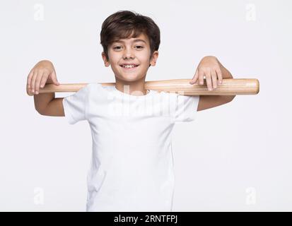 Smiley boy holding baseball bat Stock Photo