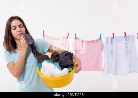 Front view woman holding yellow laundry basket Stock Photo