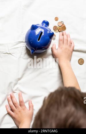 Top view child counting his money from piggy bank Stock Photo