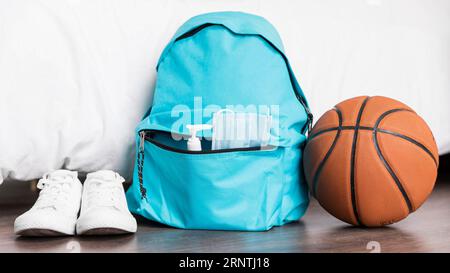 Back school arrangement with blue backpack Stock Photo