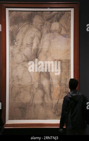 (171113) -- NEW YORK, Nov. 13, 2017 -- A visitor views the artwork of Michelangelo Roman soldiers , a cartoon fragment for the lower left part of the Crucifixion of Saint Peter during the exhibition Michelangelo: Devine Draftsman and Designer held in the Metropolitan Museum of Art in New York, the United States, on Nov. 13, 2017. The exhibition, which lasts from Nov. 13, 2017 to Feb. 12, 2018, presents a stunning range and number of works by Michelangelo Buonarroti: 133 of his drawings, three of his marble sculptures, his earliest painting, his wood architectural model for a chapel vault, as w Stock Photo