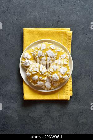 Lemon crinkle cookies on plate over blue stone background. Top view, flat lay Stock Photo