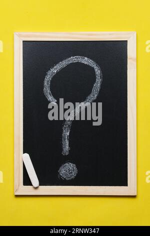Question mark is drawn in chalk blackboard on yellow background Stock Photo
