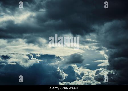 Dark storm clouds with breaking sunlight Stock Photo