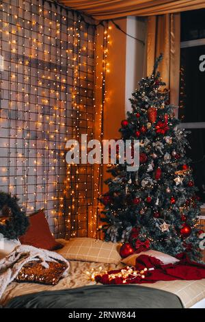 Cozy bed with Christmas pillows decorated with Christmas decor Stock Photo  - Alamy