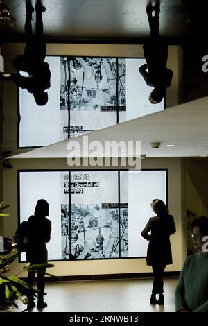 (171212) -- THE HAGUE, Dec. 12, 2017 -- People view an exhibition of documents on Nanjing Massacre during a memorial in The Hague, the Netherlands, on Dec. 12, 2017. Some 200 Chinese people and students living in the Netherlands attended a memorial of Nanjing Massacre, held one day ahead of China s National Memorial Day for Nanjing Massacre Victims. ) THE NETHERLANDS-THE HAGUE-NANJING MASSACRE-MEMORIAL RickxNederstigt PUBLICATIONxNOTxINxCHN Stock Photo