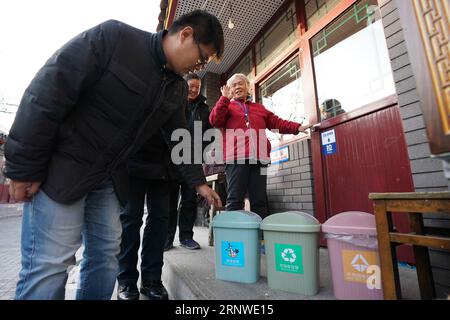 (171216) -- BEIJING, Dec. 16, 2017 -- Gao Bo (L) checks the sorted garbage cans in the Xicheng District of Beijing, capital of China, Dec. 13, 2017. Gao is one of the street chiefs appointed by the local government to manage the enviroment and order of streets. ) (zkr) CHINA-BEIJING-STREET CHIEFS(CN) JuxHuanzong PUBLICATIONxNOTxINxCHN Stock Photo