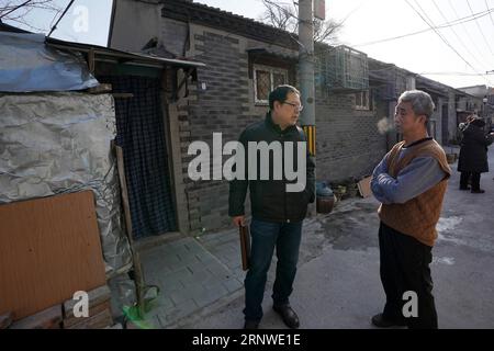 (171216) -- BEIJING, Dec. 16, 2017 -- Liu Yueming (L) talks with a resident in the Dongcheng District of Beijing, capital of China, Dec. 13, 2017. Liu is one of the street chiefs appointed by the local government to manage the enviroment and order of streets. ) (zkr) CHINA-BEIJING-STREET CHIEFS(CN) JuxHuanzong PUBLICATIONxNOTxINxCHN Stock Photo