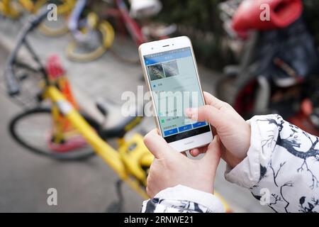 (171216) -- BEIJING, Dec. 16, 2017 -- Cao Jingjing takes photos of illegal parking bikes in the Dongcheng District of Beijing, capital of China, Dec. 14, 2017. Cao is one of the street chiefs appointed by the local government to manage the enviroment and order of streets. ) (zkr) CHINA-BEIJING-STREET CHIEFS(CN) JuxHuanzong PUBLICATIONxNOTxINxCHN Stock Photo