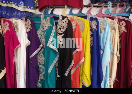 Marrakech, Morocco - Feb 10, 2023: Colourful long ladies dresses for sale in the Marrakech Souk markets Stock Photo