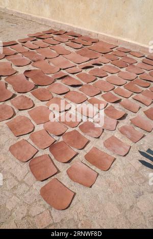 Marrakech, Morocco - Feb 10, 2023: Tanned leather pieces drying in the sun on a street in the Medina of Marrakech Stock Photo
