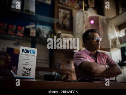(171218) -- BEIJING, Dec. 18, 2017 -- A shop owner collects payment with Paytm, an electronic payment sponsored by China s Ant Financial, in New Delhi, India, April 12, 2017. In recent years, a number of China s technological innovations have been making their moves in the world. Among them, Dockless Shared Bicycles, High-speed Rail, Alipay and E-commerce stand out with a reputation of China s four great new inventions in modern times, which have made the daily life of the public more and more convenient. ) (zkr)(zt) CHINA-FOUR GREAT NEW INVENTIONS (CN) BixXiaoyang PUBLICATIONxNOTxINxCHN Stock Photo