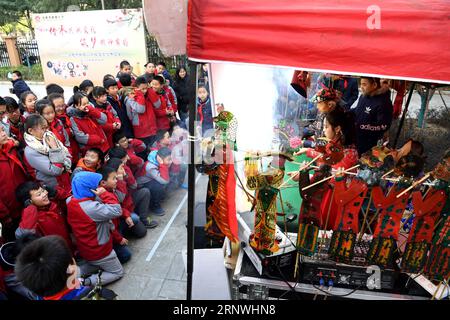 (171221) -- HEFEI, Dec. 21, 2017 -- Children watch the performance of shadow puppy at a primary school in Hefei, east China s Anhui Province, Dec. 21, 2017. The school invited local inheritors of intangible culture heritages, helping students learn more about traditional folk arts. ) (xzy) CHINA-HEFEI-FOLK ARTS-SCHOOL (CN) LiuxJunxi PUBLICATIONxNOTxINxCHN Stock Photo