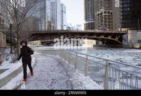 (180104) -- CHICAGO, Jan. 4, 2018 -- A man jogs along frozen Chicago River in downtown Chicago, the United States, Jan. 4, 2018. After embracing the coldest day this winter on the New Year s Day, Chicago continued staying in cold and chill. The winter storm that is slamming U.S. East Coast leads to more than 200 flight cancellation in Chicago on Thursday morning. Most of the flights cancelled have East Coast destinations, a statement of the aviation department said. ) U.S.-CHICAGO-SEVERE COLD WangxPing PUBLICATIONxNOTxINxCHN Stock Photo