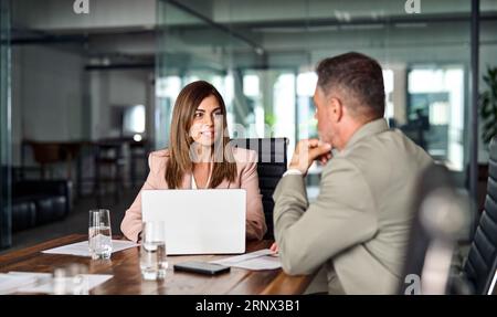 Two professional business executives working having conversation at meeting. Stock Photo