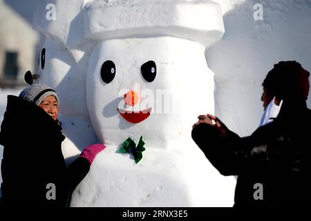 (180111) -- HARBIN, Jan. 11, 2018 -- People pose for photos with snowman sculptures at an ice and snow park in Harbin, capital of northeast China s Heilongjiang Province, Jan. 11, 2018. Altogether 2,018 cute snowmen were displayed here to greet the year 2018. ) (zwx) CHINA-HARBIN-SNOWMAN (CN) WangxKai PUBLICATIONxNOTxINxCHN Stock Photo