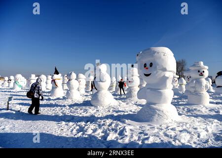 (180111) -- HARBIN, Jan. 11, 2018 -- People watch snowman sculptures at an ice and snow park in Harbin, capital of northeast China s Heilongjiang Province, Jan. 11, 2018. Altogether 2,018 cute snowmen were displayed here to greet the year 2018. ) (zwx) CHINA-HARBIN-SNOWMAN (CN) WangxKai PUBLICATIONxNOTxINxCHN Stock Photo