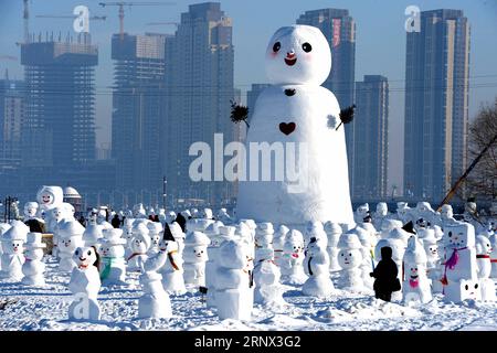 (180111) -- HARBIN, Jan. 11, 2018 -- People watch snowman sculptures at an ice and snow park in Harbin, capital of northeast China s Heilongjiang Province, Jan. 11, 2018. Altogether 2,018 cute snowmen were displayed here to greet the year 2018. ) (zwx) CHINA-HARBIN-SNOWMAN (CN) WangxKai PUBLICATIONxNOTxINxCHN Stock Photo