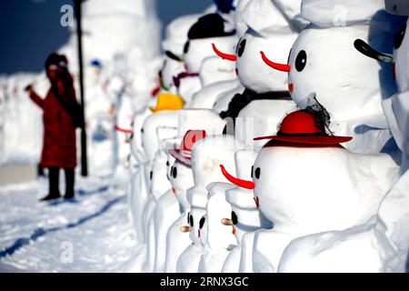 (180111) -- HARBIN, Jan. 11, 2018 -- People pose for photos with snowman sculptures at an ice and snow park in Harbin, capital of northeast China s Heilongjiang Province, Jan. 11, 2018. Altogether 2,018 cute snowmen were displayed here to greet the year 2018. ) (zwx) CHINA-HARBIN-SNOWMAN (CN) WangxKai PUBLICATIONxNOTxINxCHN Stock Photo