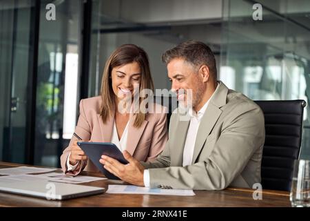 Professional business managers working using tablet at office meeting. Stock Photo