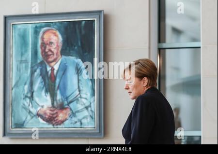 (180112) -- BEIJING, Jan. 12, 2018 -- German Chancellor Angela Merkel walks past a portrait of former German Chancellor Helmut Kohl as she arrives to sign the condolences book at German Chancellery in Berlin, capital of Germany, on June 18, 2017. Former German Chancellor Helmut Kohl died at his home in Germany s Ludwigshafen on June 16, 2017 at the age of 87. ) XINHUA-PICTURES OF THE YEAR 2017-WORLD ShanxYuqi PUBLICATIONxNOTxINxCHN Stock Photo