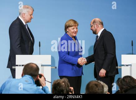 (180112) -- BERLIN, Jan. 12, 2018 -- German Chancellor and leader of German Christian Democratic Union (CDU) Angela Merkel (C) shakes hands with leader of German Social Democratic Party (SPD) Martin Schulz (R) after a joint press conference at the headquarters of SPD, in Berlin, Germany, on Jan. 12, 2018. German Chancellor Angela Merkel s conservatives and the Social Democrats (SPD) on Friday achieved a breakthrough in their exploratory talks aimed at forming a new coalition government, local media reported. )(srb) GERMANY-BERLIN-COALITION TALKS-BREAKTHROUGH ShanxYuqi PUBLICATIONxNOTxINxCHN Stock Photo