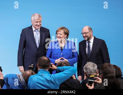 (180112) -- BERLIN, Jan. 12, 2018 -- German Chancellor and leader of German Christian Democratic Union (CDU) Angela Merkel (C), leader of German Christian Social Union (CSU) Horst Seehofer (L) and leader of German Social Democratic Party (SPD) Martin Schulz pose for photos after a joint press conference at the headquarters of SPD, in Berlin, Germany, on Jan. 12, 2018. German Chancellor Angela Merkel s conservatives and the Social Democrats (SPD) on Friday achieved a breakthrough in their exploratory talks aimed at forming a new coalition government, local media reported. )(srb) GERMANY-BERLIN- Stock Photo