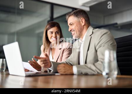 Two professional business executives working together at office meeting. Stock Photo