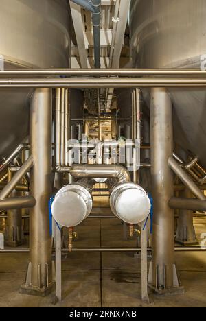 Piping, tubing, and vats in a commercial beer brewery. Stock Photo