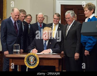 (180119) -- NEW YORK, Jan. 19, 2018 -- File photo released by NASA on Dec. 11, 2017 shows U.S. President Donald Trump (Front) signing the Space Policy Directive 1 at the White House in Washington D.C., the United States, on Dec. 11, 2017. Donald Trump on Monday signed his administration s first space policy directive, formally directing the U.S. space agency NASA to send astronauts back to the moon and eventually Mars. Jan. 20, 2018 reaches one-year mark for Donald Trump as the 45th president of the United States. One year into U.S. President Donald Trump s presidency, the uncertainties and an Stock Photo