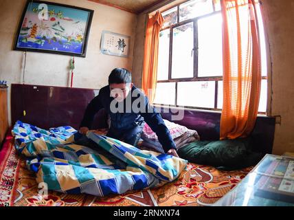 (180206) -- KANGLE, Feb. 6, 2018 -- Sun Jianjun makes his bed at home in Xinzhuang Village, Basong Township, Kangle County of northwest China s Gansu Province, Feb. 3, 2018. Spring Festival, or Chinese Lunar New Year, falls on Feb. 16 this year. Hundreds of millions of Chinese will return to their hometowns for family gatherings. 14-year-old Sun Jianjun and his 15 schoolmates are among these travellers eager back to home. On Feb. 1, the first day of the 2018 Spring Festival travel rush, they stepped onto a train in Nantong of east China s Jiangsu Province on a journey to home that is more than Stock Photo