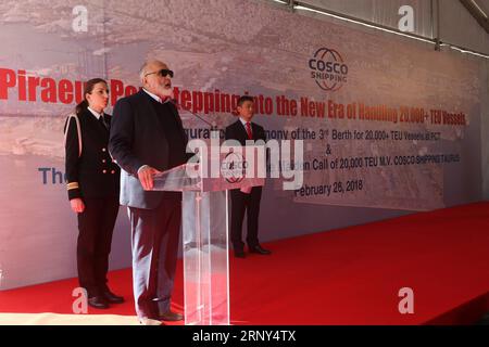 (180227) -- PIRAEUS PORT, Feb. 27, 2018 -- Greek Shipping Minister Panayiotis Kouroumblis (front) speaks during a ceremony for the welcome of the maiden call of China s COSCO Shipping Taurus and the inauguration of the 3rd berth for 20,000 plus twenty-foot equivalent unit (TEU) vessels at Piraeus Container Terminal (PCT) of Piraeus port, Greece, Feb. 26, 2018. Piraeus port, the largest harbor in Greece, entered a new era of handling 20,000 plus TEU vessels on Monday when China s COSCO Shipping Taurus giga container vessel, one of the biggest worldwide, docked here. The 400 m Taurus is the larg Stock Photo