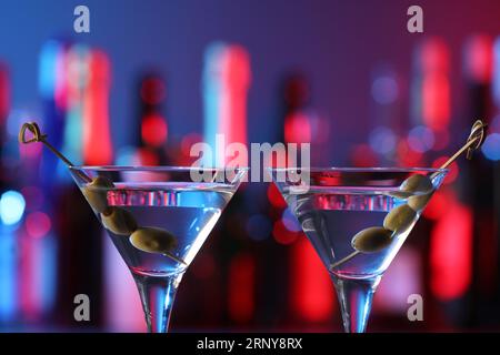 Martini glasses with cocktail and olives in bar, closeup Stock Photo