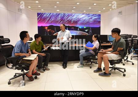 (180313) -- GUIYANG, March 13, 2018 -- File photo taken on Aug. 10, 2017, shows staff members communicating in the control room of the Five-hundred-meter Aperture Spherical Radio Telescope (FAST) in Pingtang County, southwest China s Guizhou Province. China s FAST, the world s largest single-dish radio telescope, has discovered 11 new pulsars so far, the National Astronomical Observatories of China (NAOC) said Tuesday. )(wsw) CHINA-GUIZHOU-FAST-11 NEW PULSARS (CN) OuxDongqu PUBLICATIONxNOTxINxCHN Stock Photo