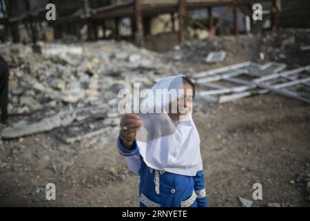 (180315) -- SARPOL-E ZAHAB, March 15, 2018 -- Paria plays amidst the debris of buildings in Sarpol-e Zahab city, western Iran, on March 11, 2018. Paria, 10-year-old Iranian-Kurdish girl, lost her father during a 7.3-magnitude earthquake on Nov. 12, 2017. Now, she is living with her mother and only brother in a conex home, as their house was completely destroyed during the tremor. She has had her father as the hero of her life, she sobbed. Asked what her top dream in her life is, she dropped her head saying in low voice: I cannot think of another disaster like this for anybody in the world. ) ( Stock Photo