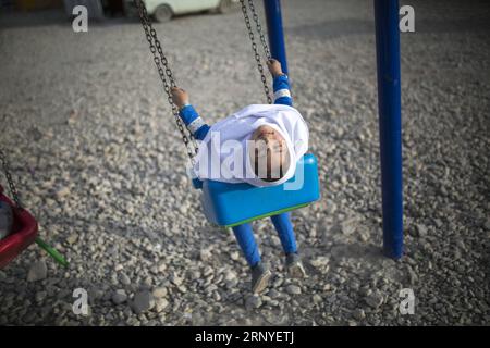 (180315) -- SARPOL-E ZAHAB, March 15, 2018 -- Paria plays on a swing outside her conex home in Sarpol-e Zahab city, western Iran, on March 11, 2018. Paria, 10-year-old Iranian-Kurdish girl, lost her father during a 7.3-magnitude earthquake on Nov. 12, 2017. Now, she is living with her mother and only brother in a conex home, as their house was completely destroyed during the tremor. She has had her father as the hero of her life, she sobbed. Asked what her top dream in her life is, she dropped her head saying in low voice: I cannot think of another disaster like this for anybody in the world. Stock Photo