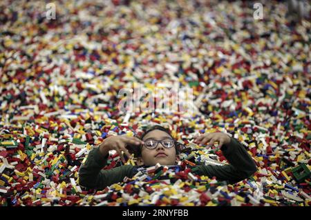 (180317) -- BOGOTA, March 17, 2018 -- A girl plays with LEGO plastic bricks during the LEGO Fun Fest 2018, in Bogota, Colombia, on March 16, 2018. ) (cr) (da) (psw) COLOMBIA-BOGOTA-LEGO FESTIVAL JhonxPaz PUBLICATIONxNOTxINxCHN Stock Photo